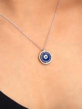 925 silver necklace with round blue evil eye pendant framed in silver detailing, symbolizing protection and modern elegance
