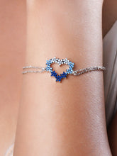 925 silver bracelet with dual chain and open heart charm embellished with white and blue stones