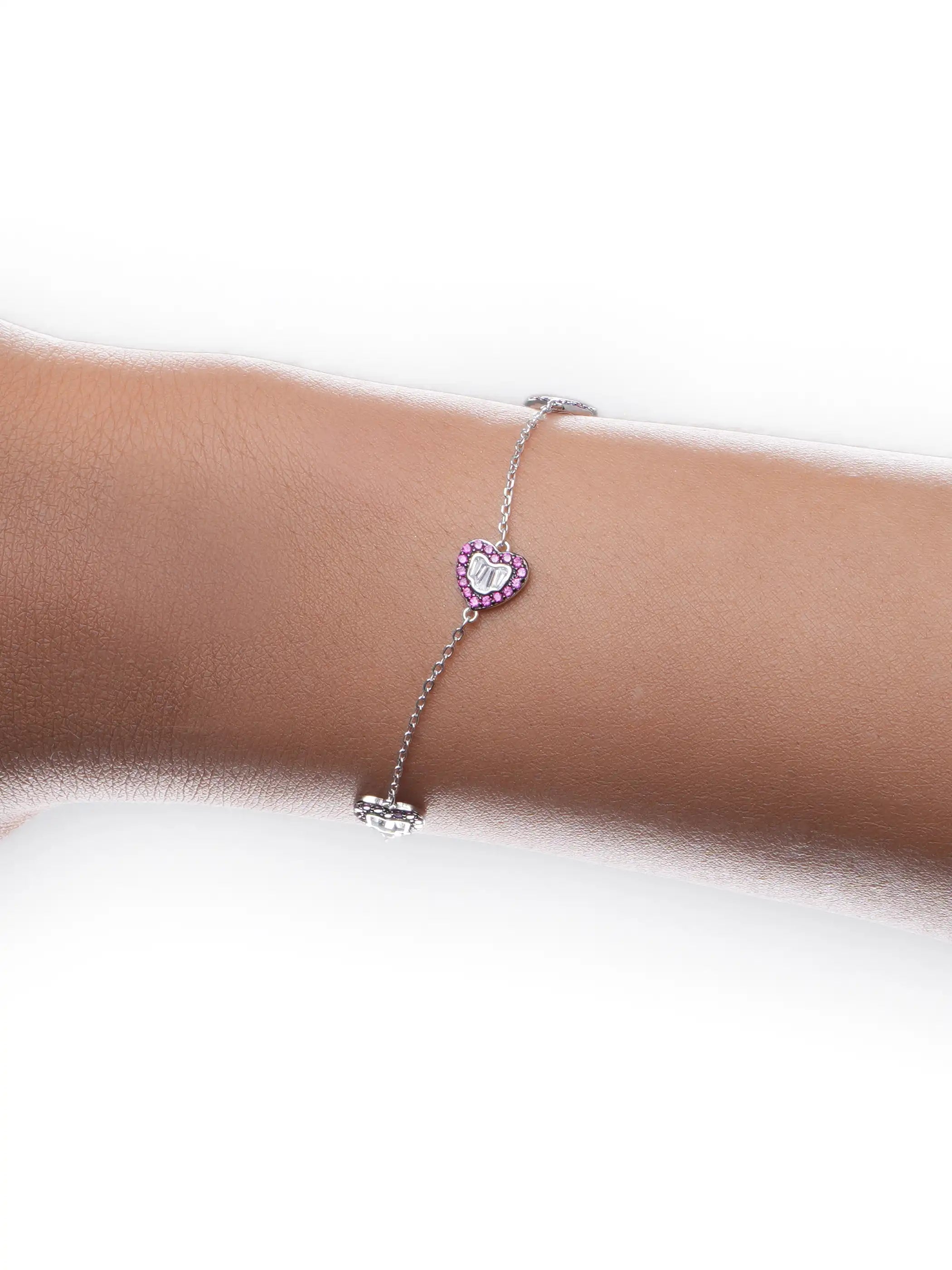 925 silver bracelet with three pink crystal-studded heart charms featuring silver detailing on delicate chain