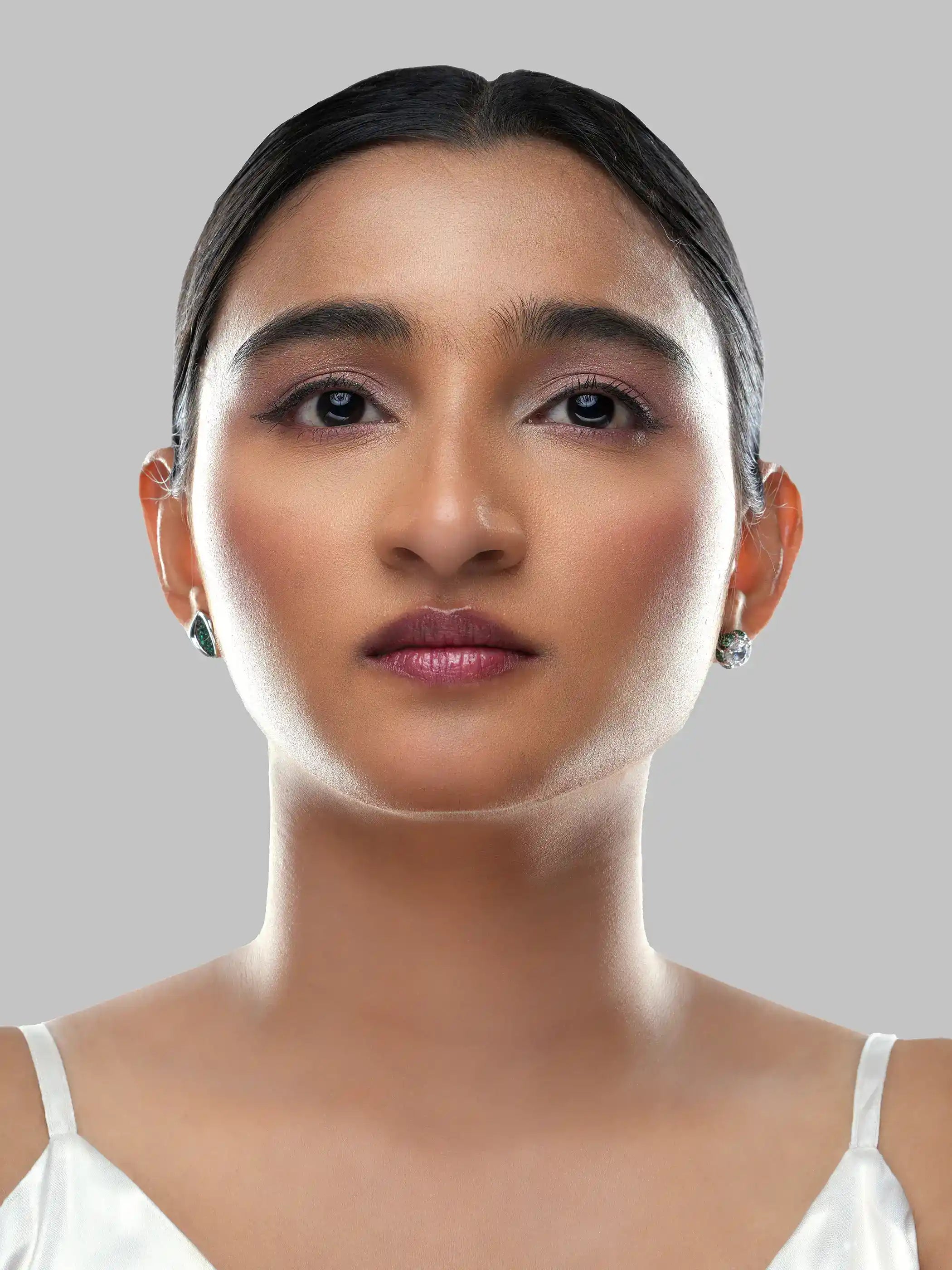 925 silver mismatched stud earrings with green leaf motif and crystal-studded floral design