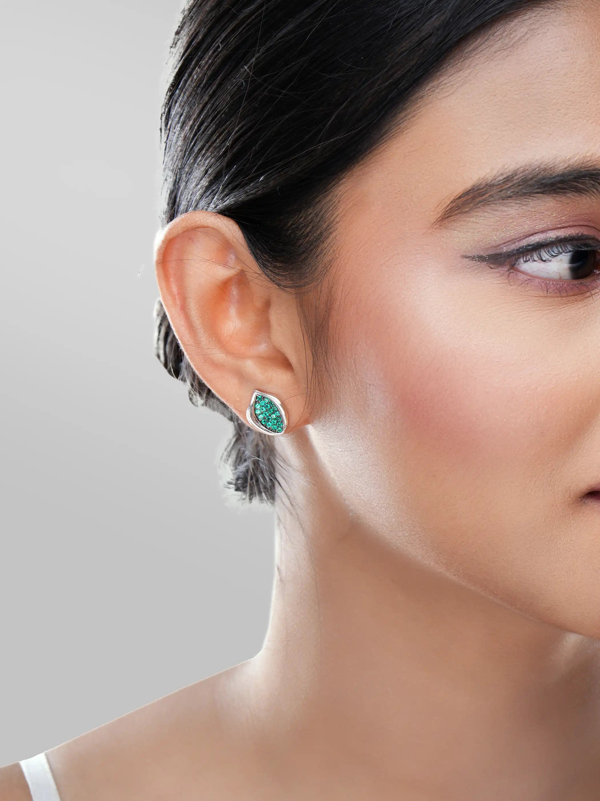 925 silver mismatched stud earrings with green leaf motif and crystal-studded floral design