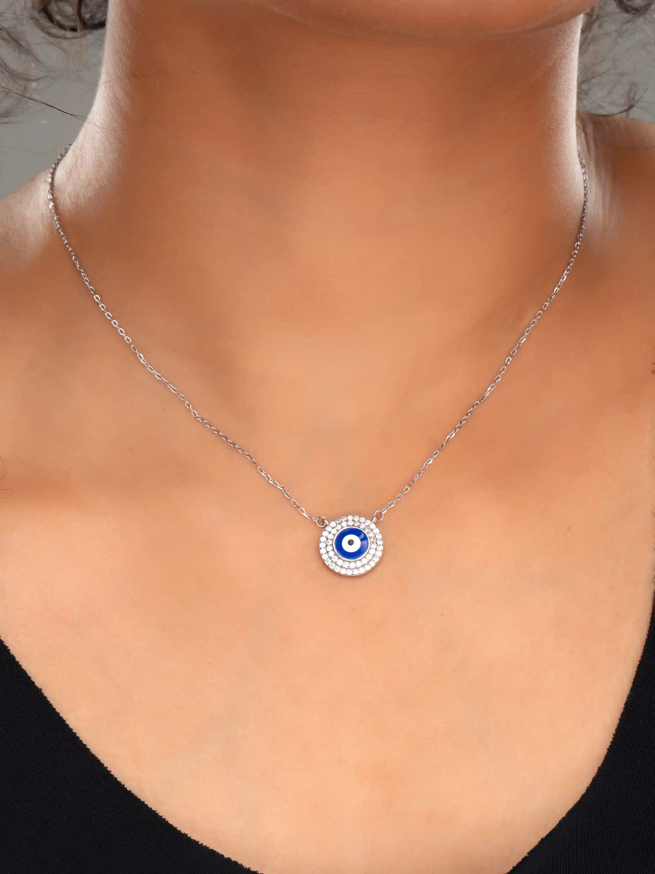 925 silver necklace with a round blue evil eye pendant surrounded by sparkling crystals on a delicate chain for everyday protection and style