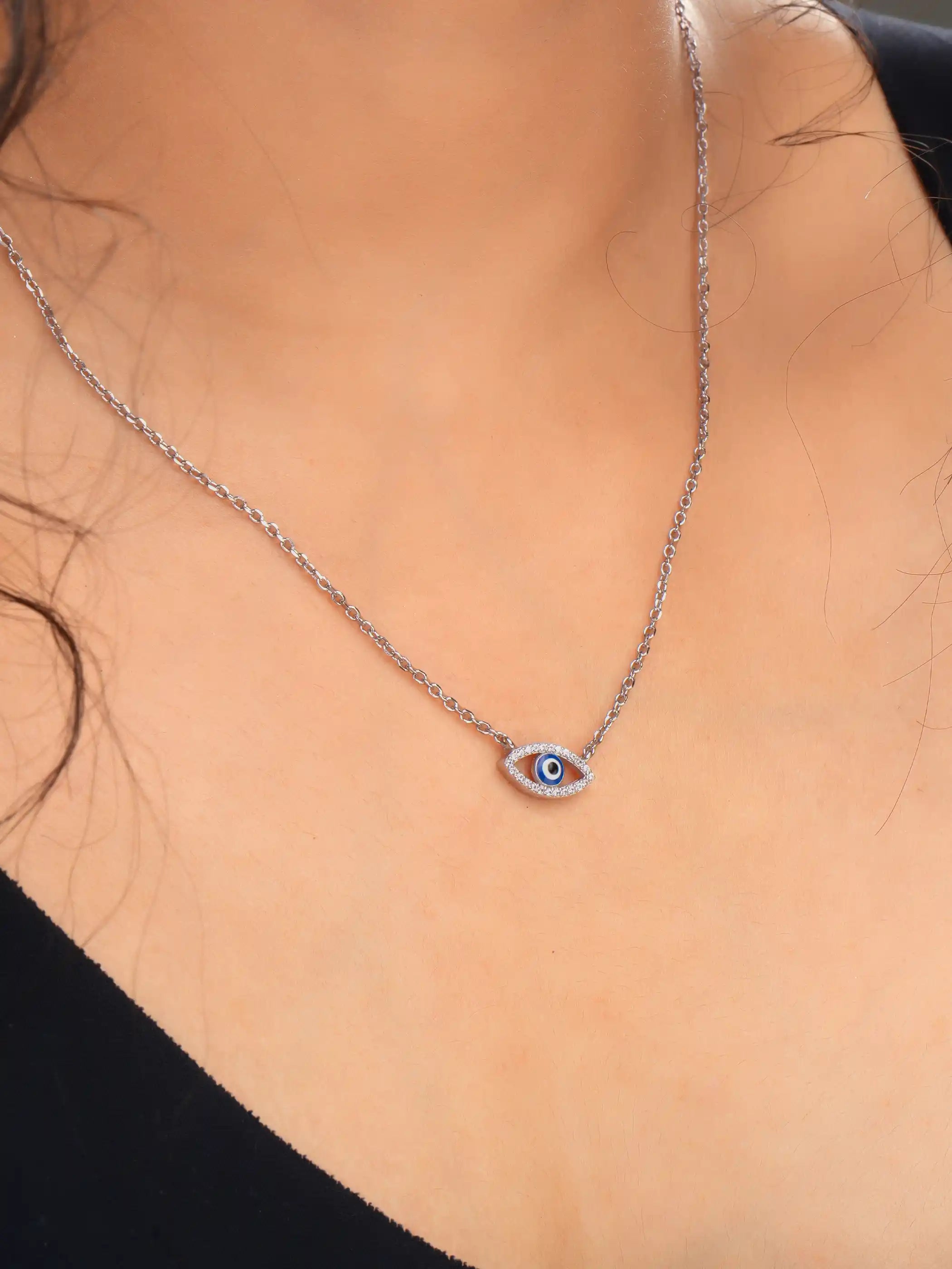 925 silver necklace with delicate chain and blue evil eye pendant in an open-eye design, symbolizing protection and style
