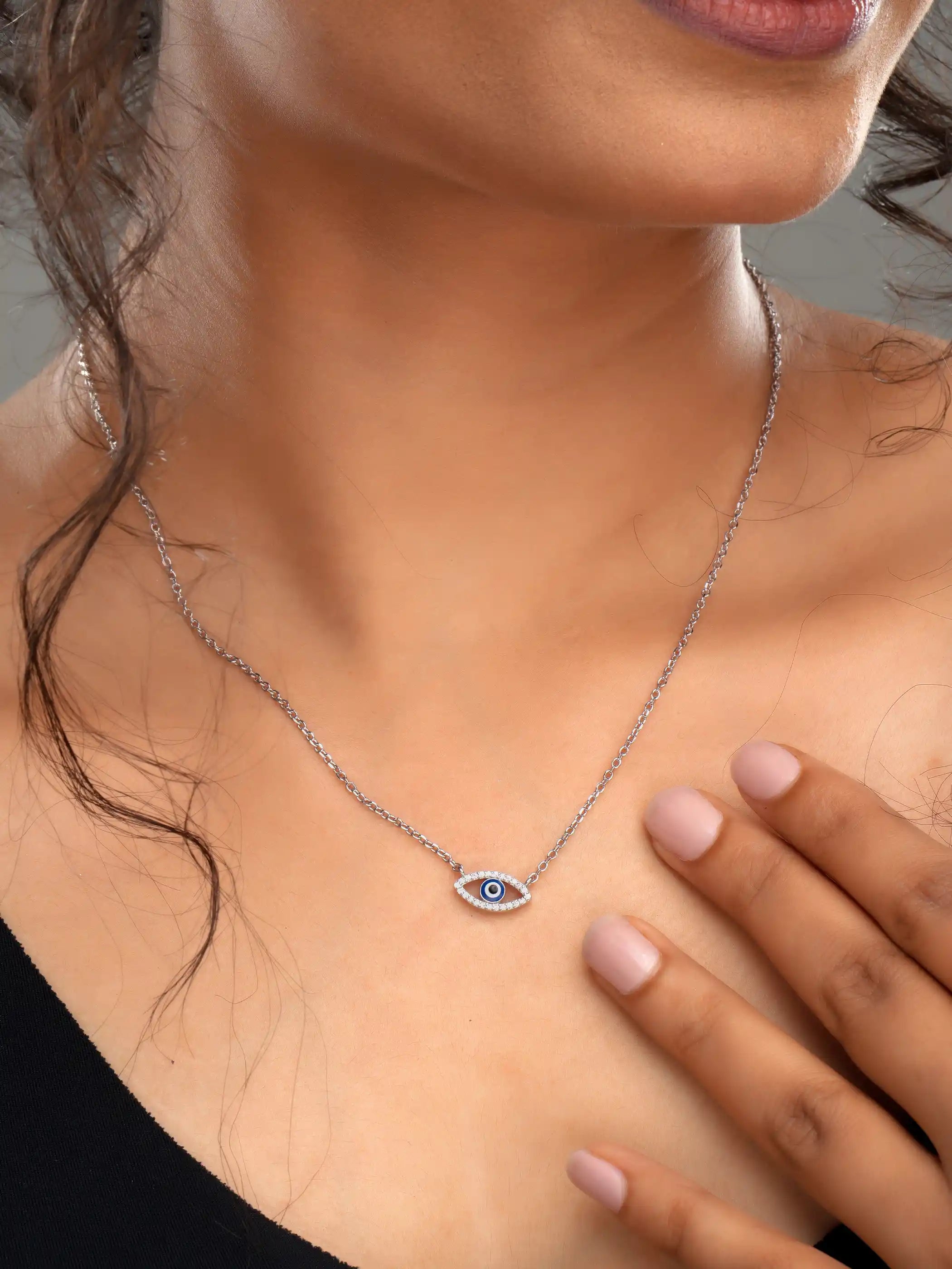 925 silver necklace with delicate chain and blue evil eye pendant in an open-eye design, symbolizing protection and style