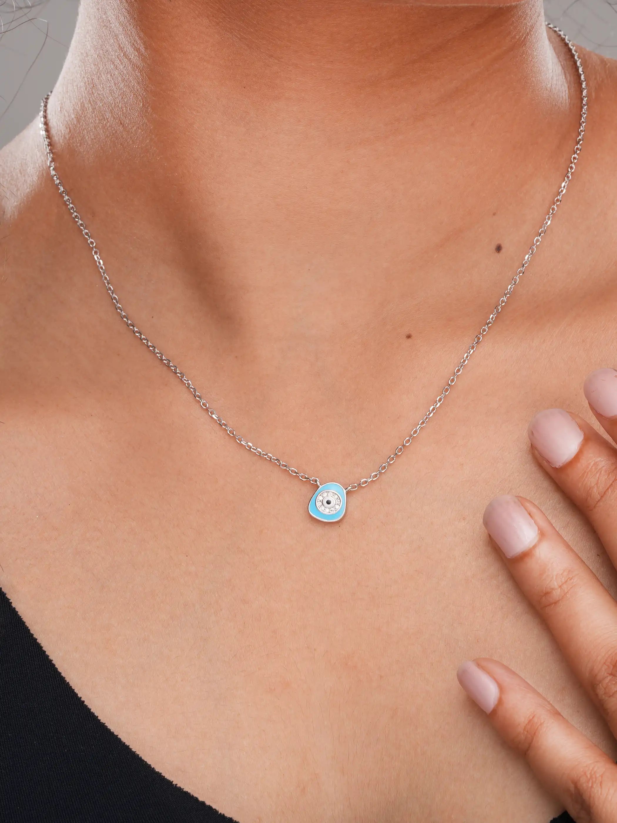 925 silver necklace with a light blue evil eye pendant surrounded by crystal detailing on a delicate chain for everyday protection and style