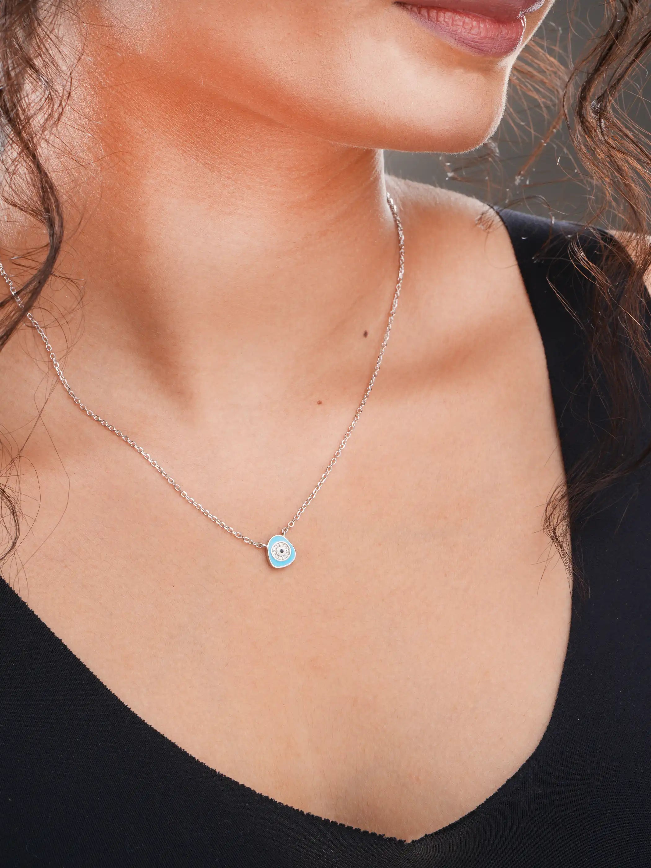925 silver necklace with a light blue evil eye pendant surrounded by crystal detailing on a delicate chain for everyday protection and style