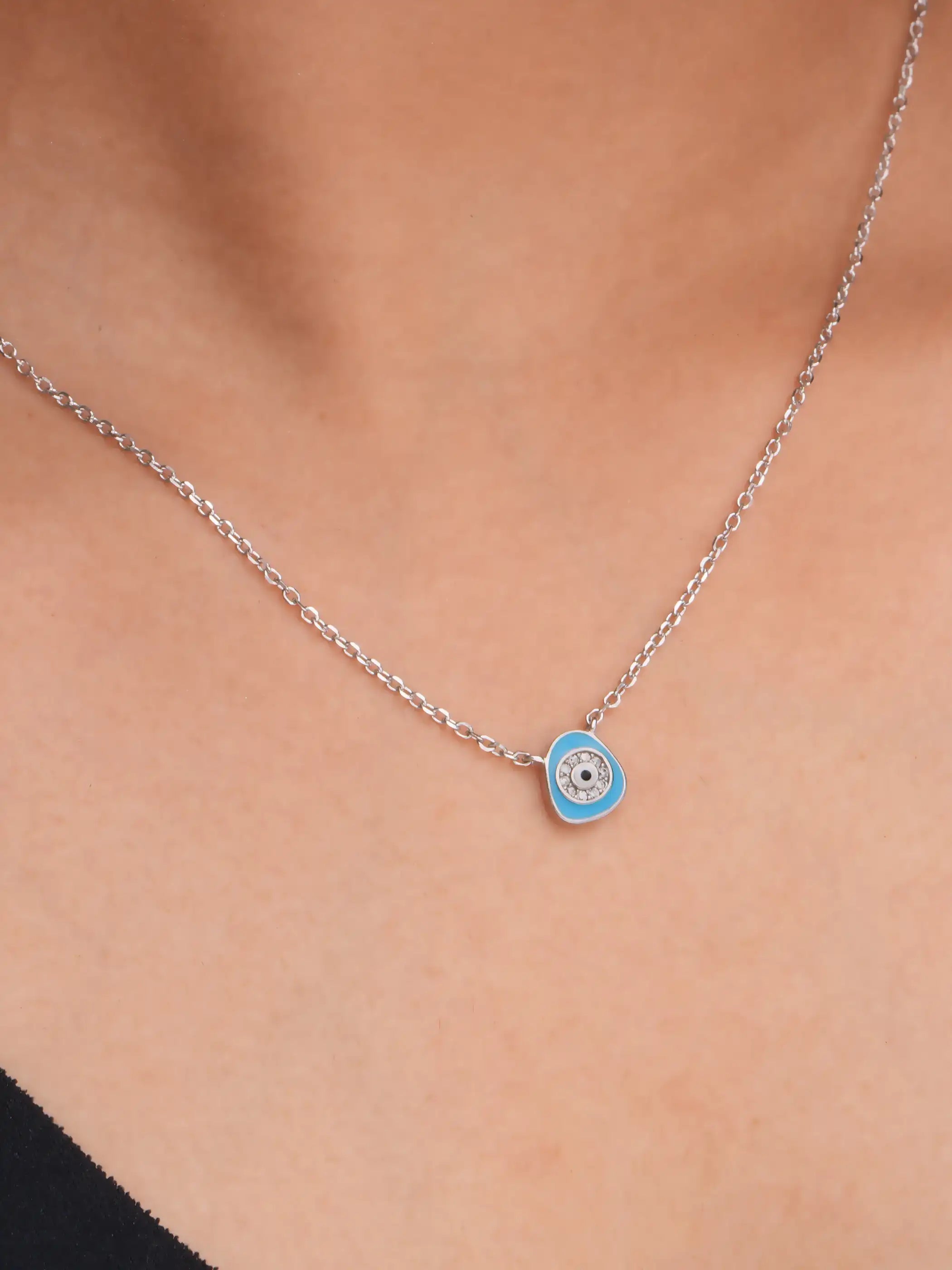 925 silver necklace with a light blue evil eye pendant surrounded by crystal detailing on a delicate chain for everyday protection and style