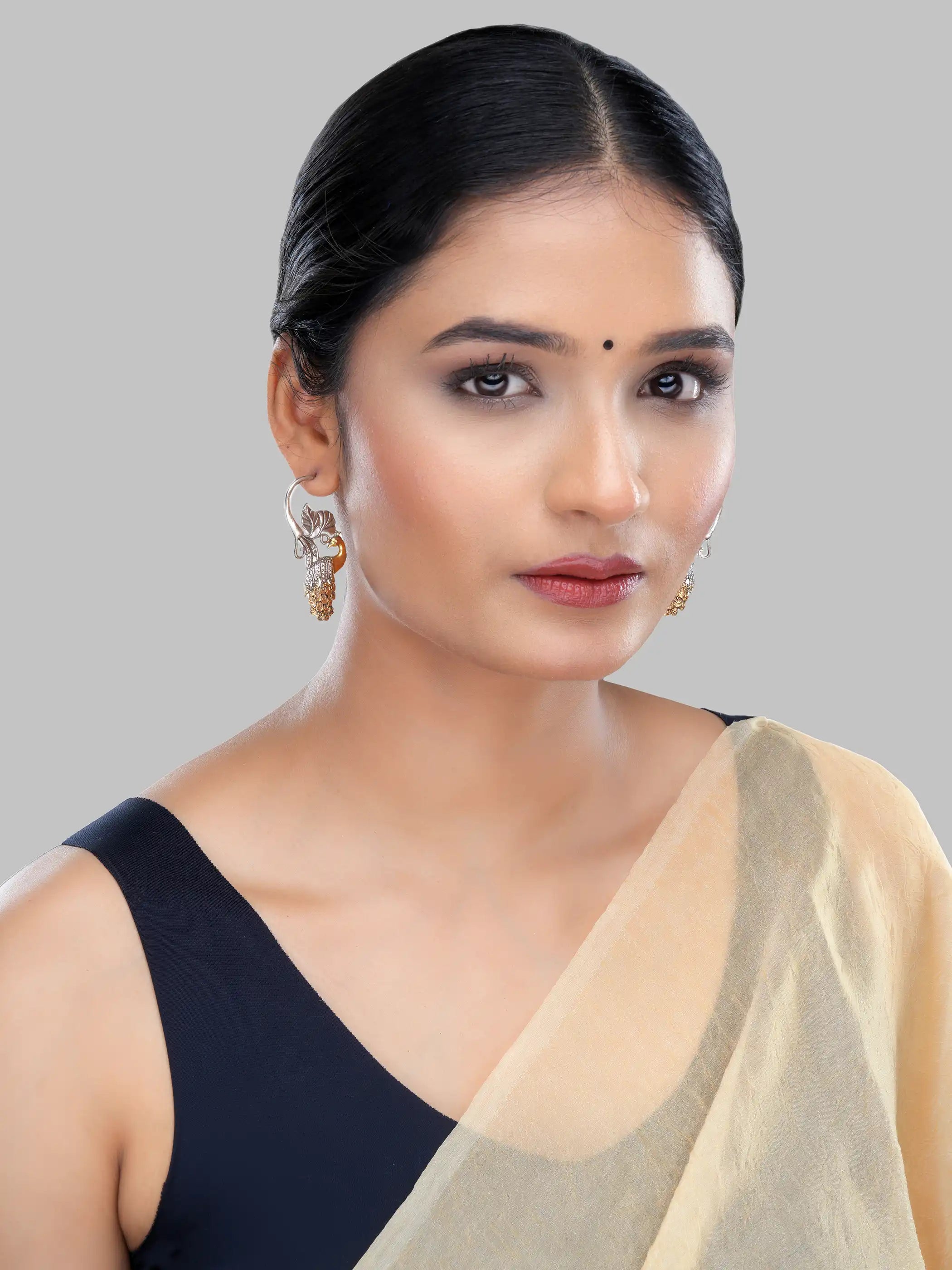 925 silver dual-tone peacock motif earrings with gold-plated feathers and oxidized leaf detailing