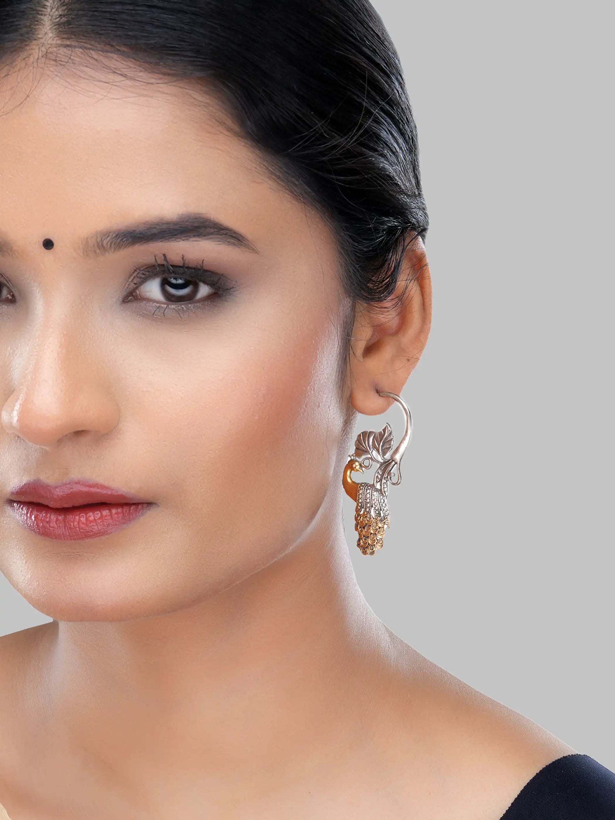 925 silver dual-tone peacock motif earrings with gold-plated feathers and oxidized leaf detailing