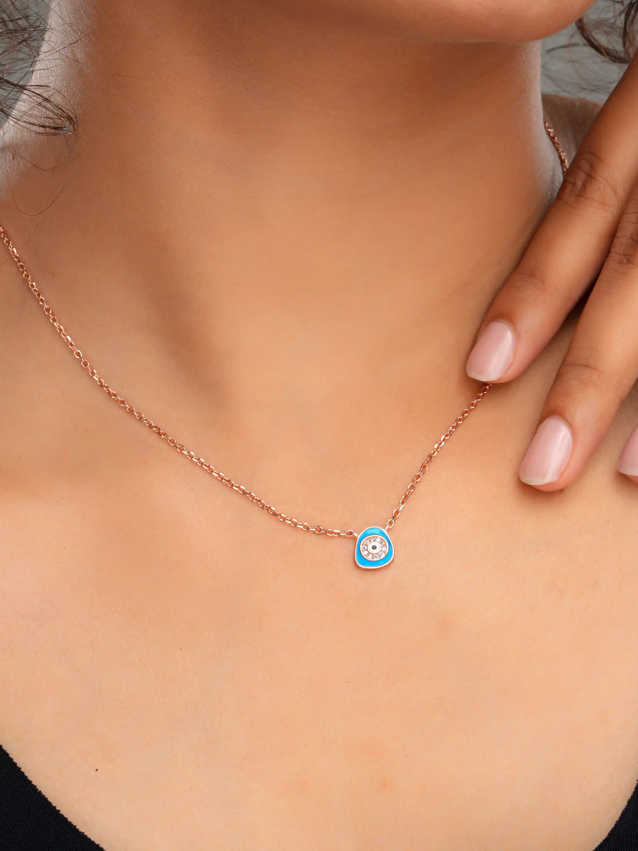 925 silver rose gold plated necklace with a blue evil eye pendant encircled by crystals on a delicate chain for everyday protection and style