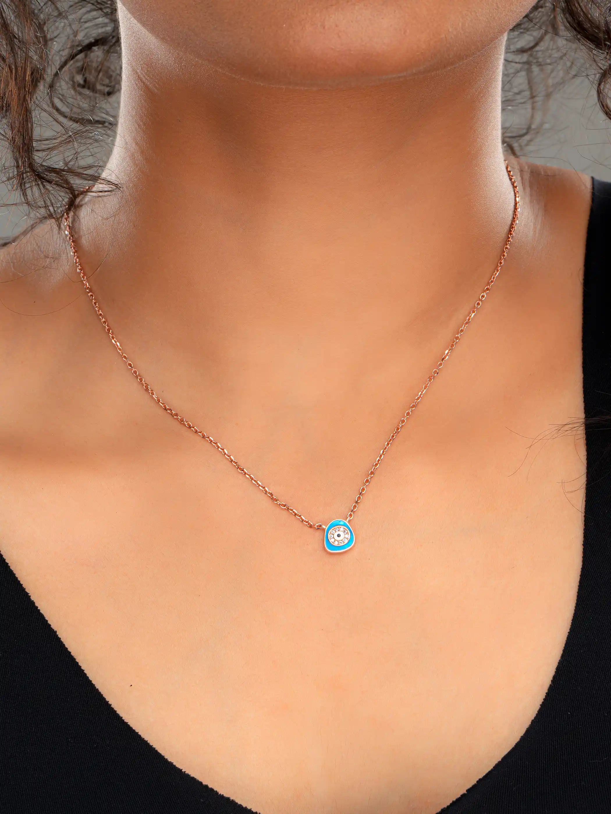 925 silver rose gold plated necklace with a blue evil eye pendant encircled by crystals on a delicate chain for everyday protection and style