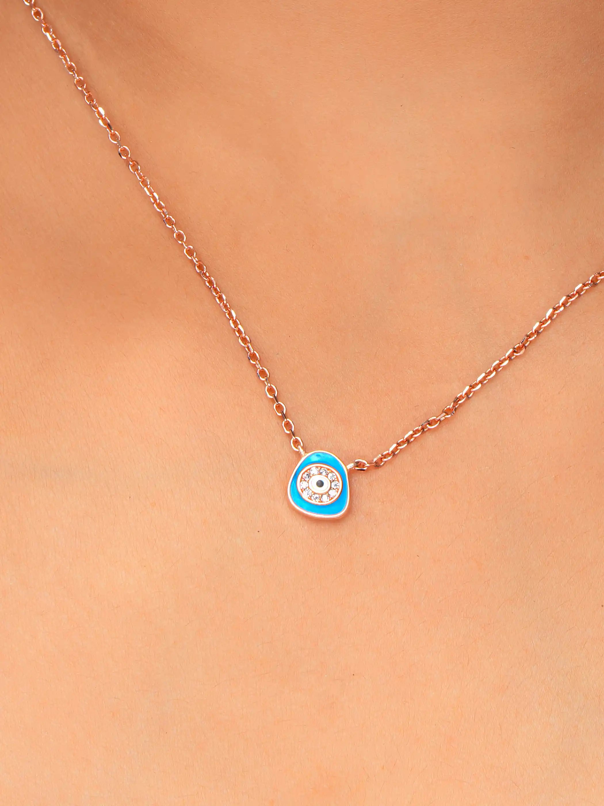 925 silver rose gold plated necklace with a blue evil eye pendant encircled by crystals on a delicate chain for everyday protection and style
