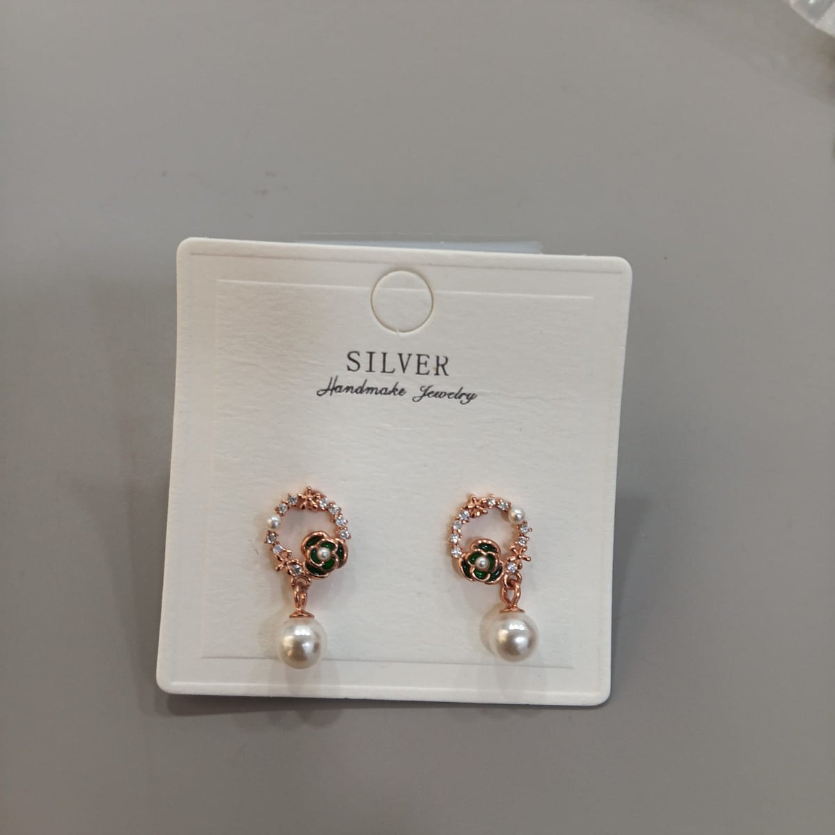 925 sterling silver drop earrings with green floral circles and ivory-toned bead drops, front and side views.