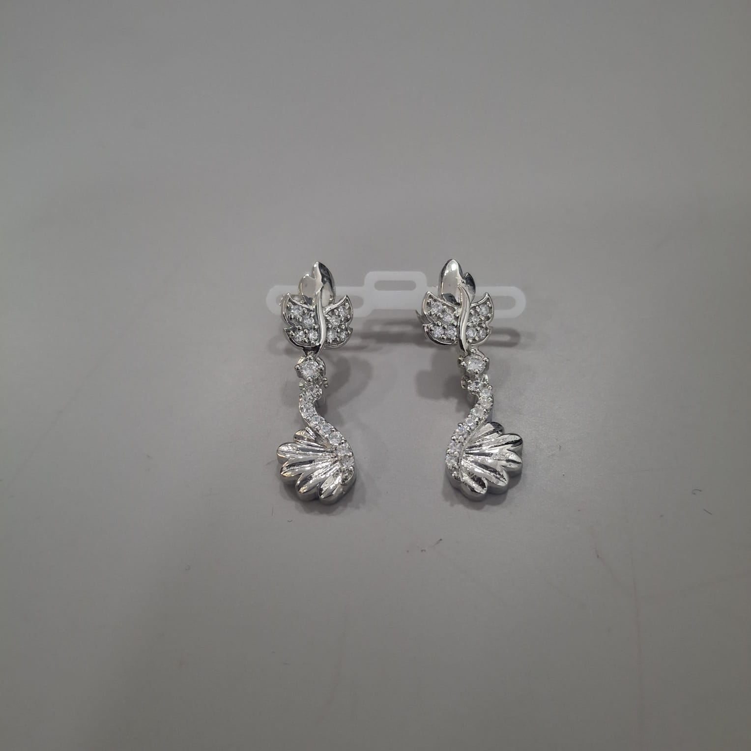 925 sterling silver drop earrings with sculpted leaf top and a sweeping swan-like lower form, front and side views.