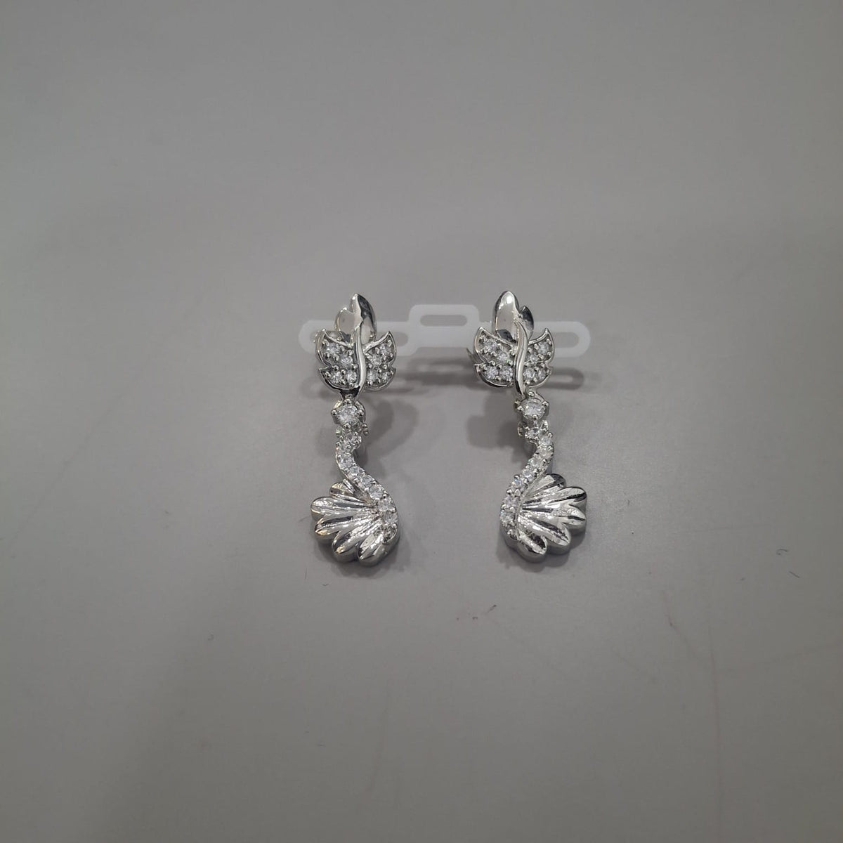 925 sterling silver drop earrings with sculpted leaf top and a sweeping swan-like lower form, front and side views.