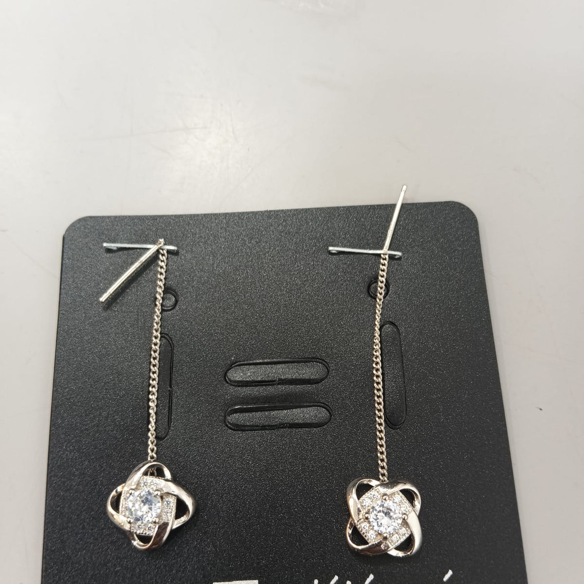 925 sterling silver Sui Dhaga earring with interlaced halo and clear centre, shown from front and side.