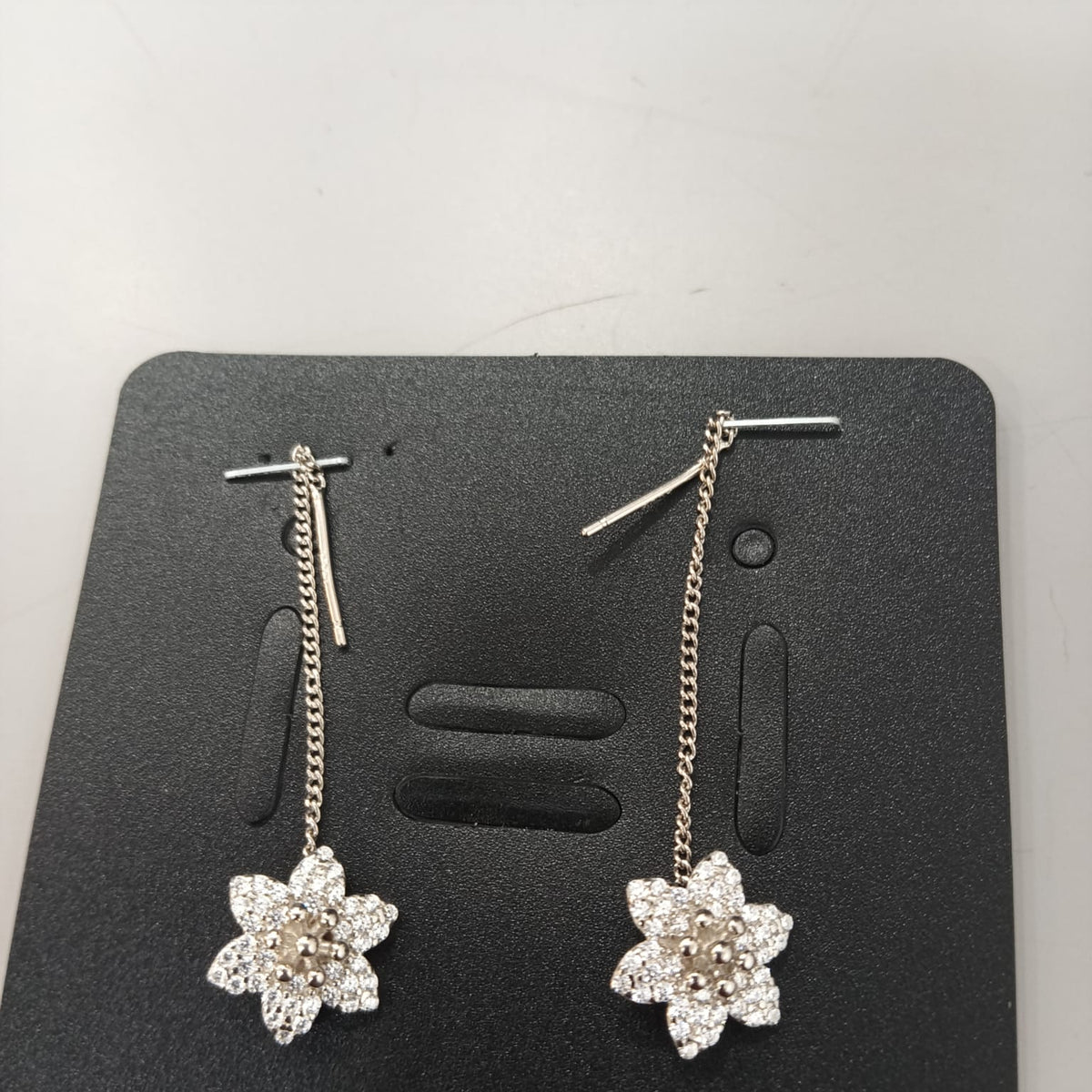 925 sterling silver Sui Dhaga earring with stone-set six-petal lotus, shown from front and side.