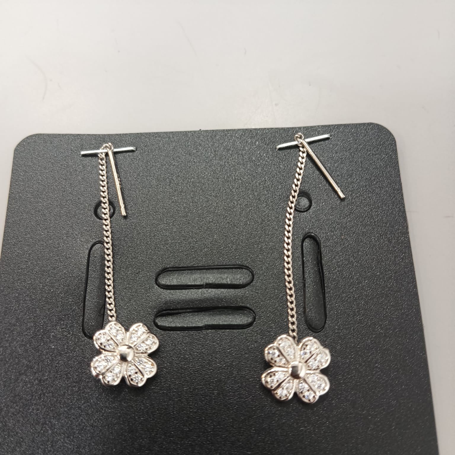925 sterling silver Sui Dhaga earring with rounded petals and polished centre, shown from front and side.