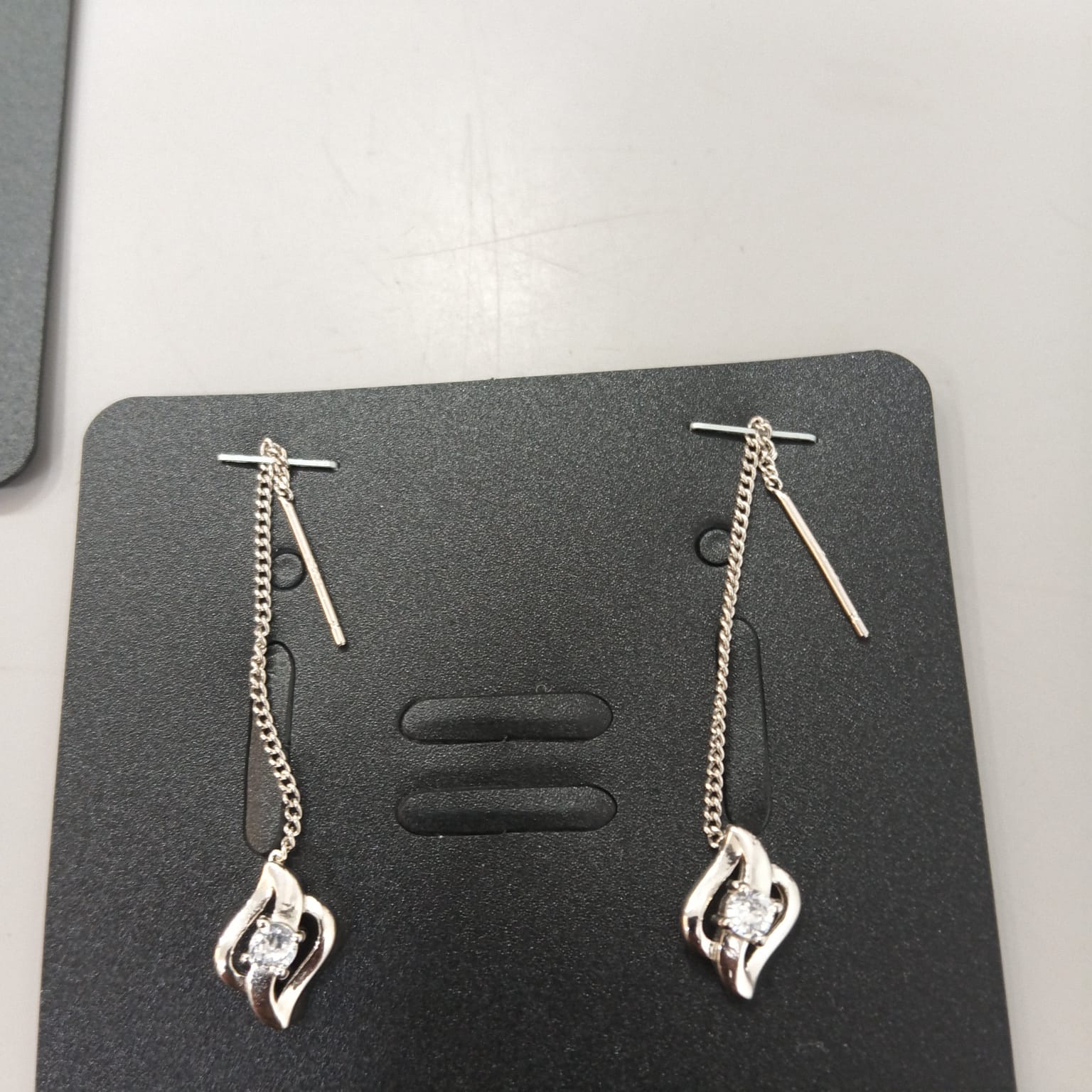 925 sterling silver Sui Dhaga earring with open flame frame and clear centre, shown from front and side.