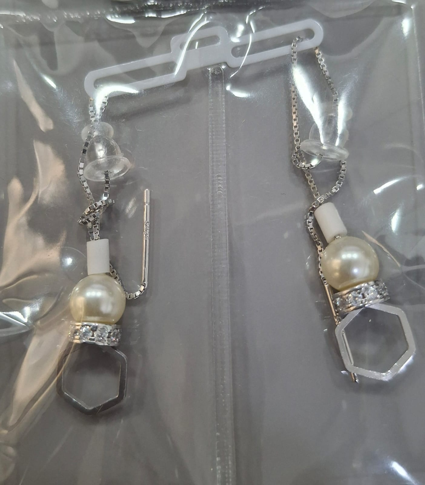 925 sterling silver Sui Dhaga earring with open hexagon and ivory-toned bead, shown from front and side.