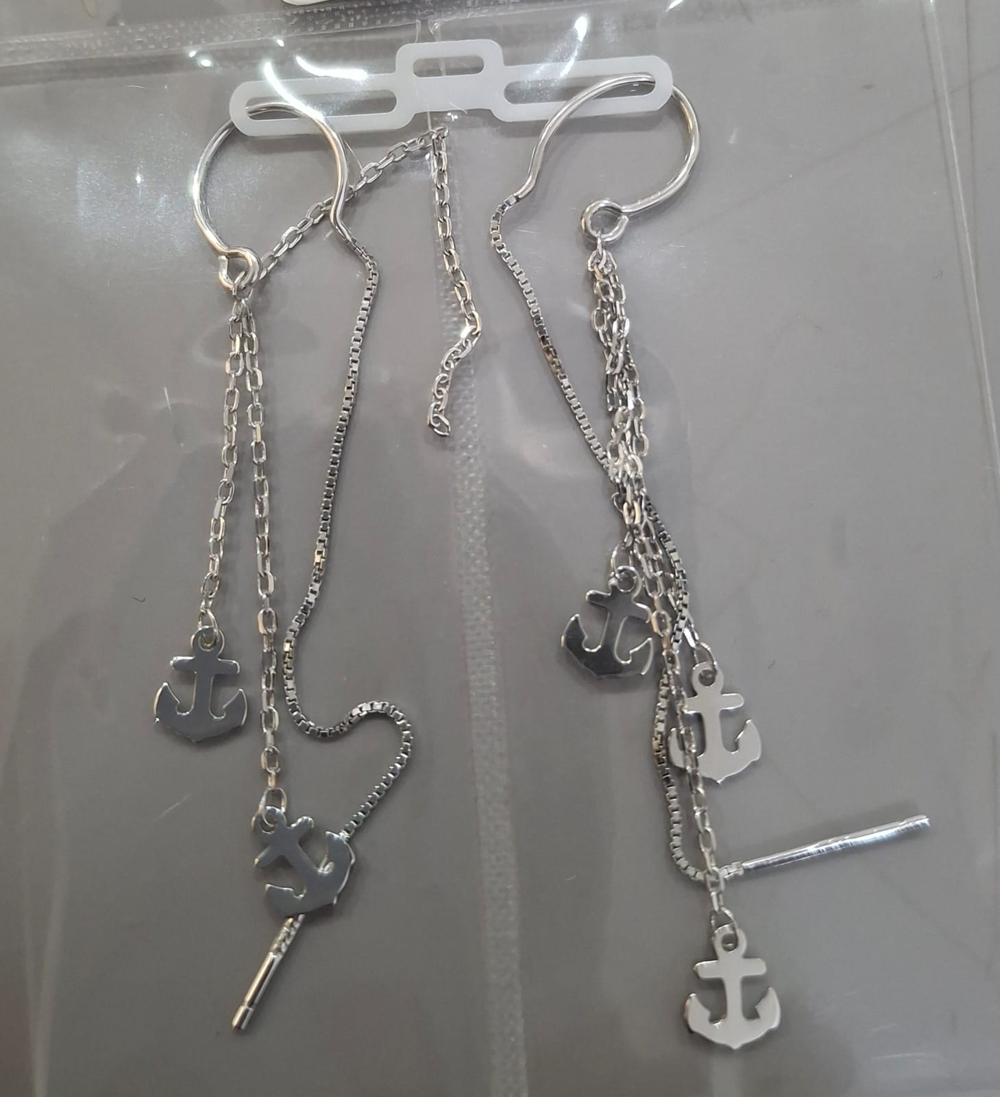 925 sterling silver Sui Dhaga earring with triple anchor charm cascade, shown from front and side.