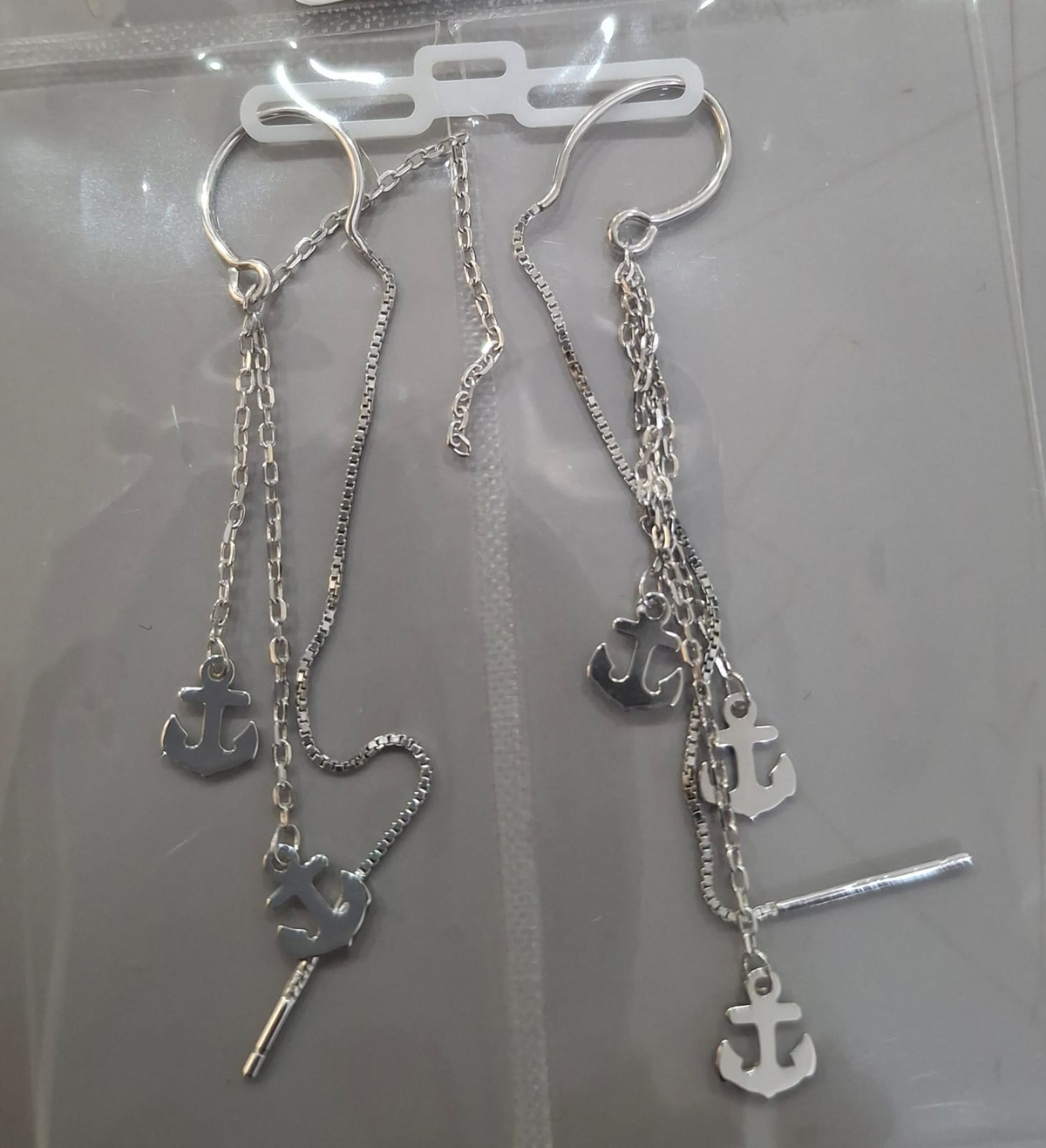 925 sterling silver Sui Dhaga earring with triple anchor charm cascade, shown from front and side.