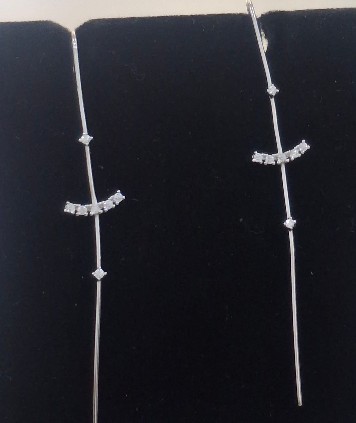 925 sterling silver ear needle pin with curved stone arc and round accents, shown from front and side.