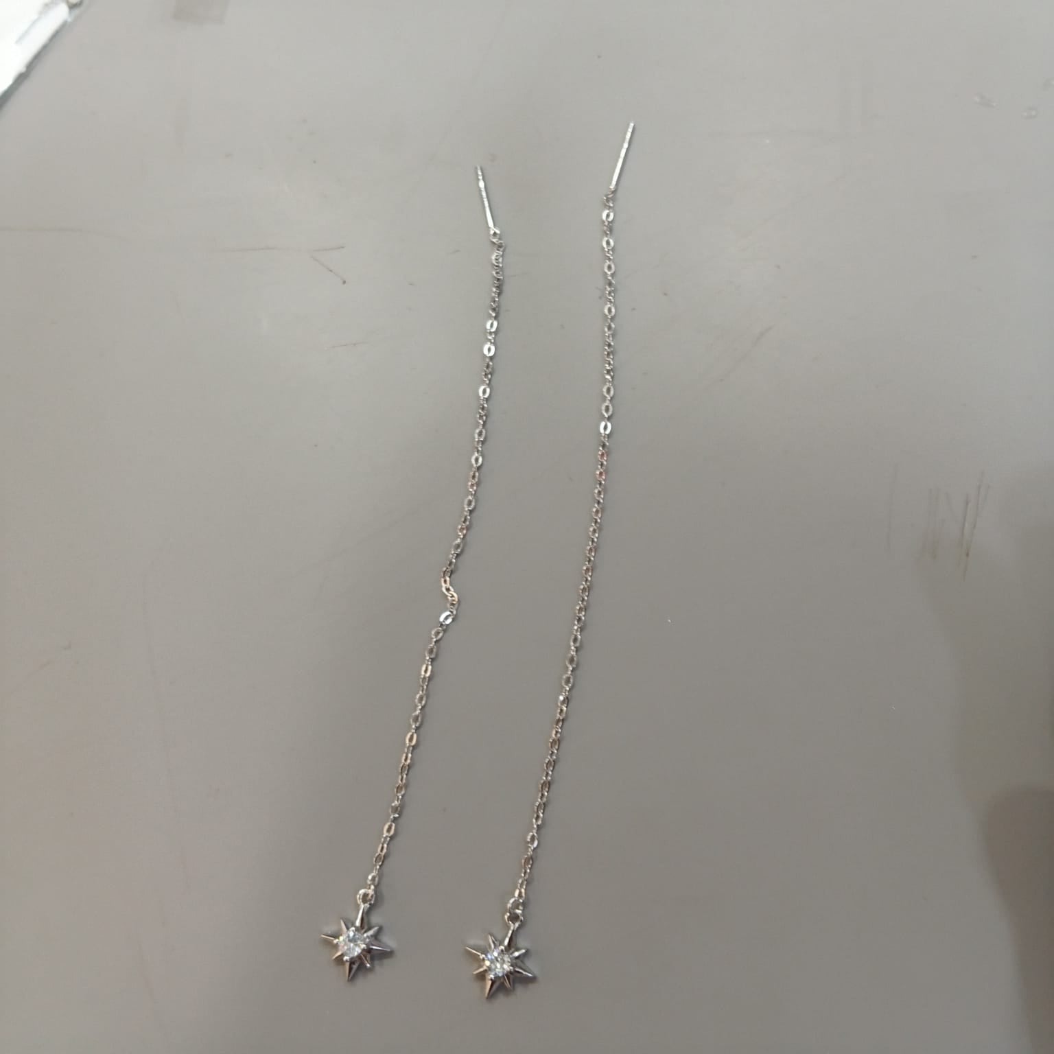 925 sterling silver Sui Dhaga earring with eight-point starburst and clear centre, shown from front and side.