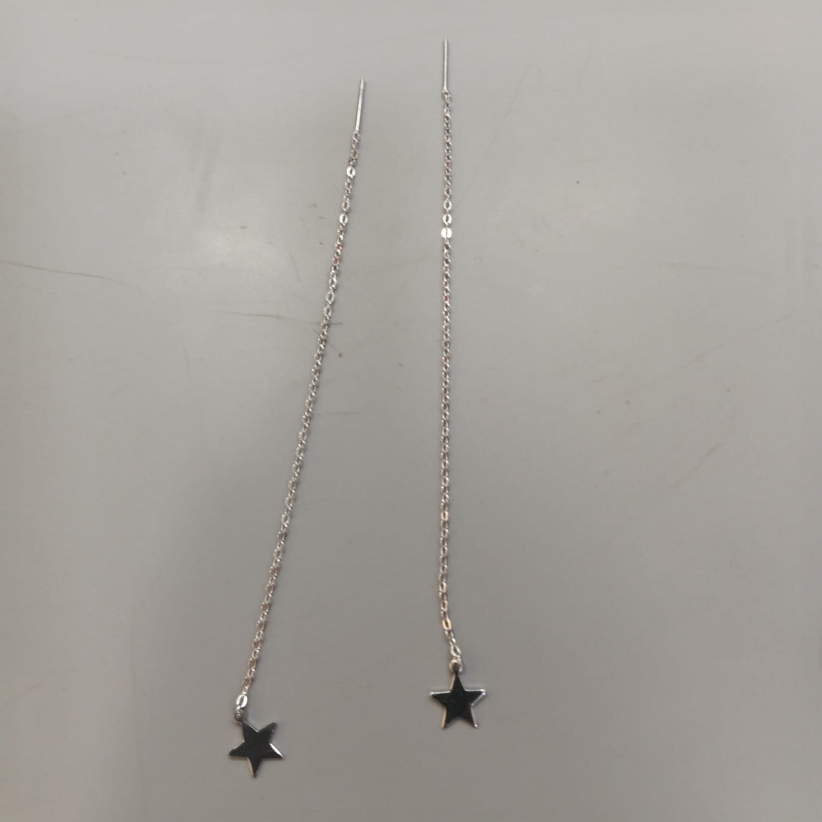 925 sterling silver Sui Dhaga earring with polished five-point star, shown from front and side.