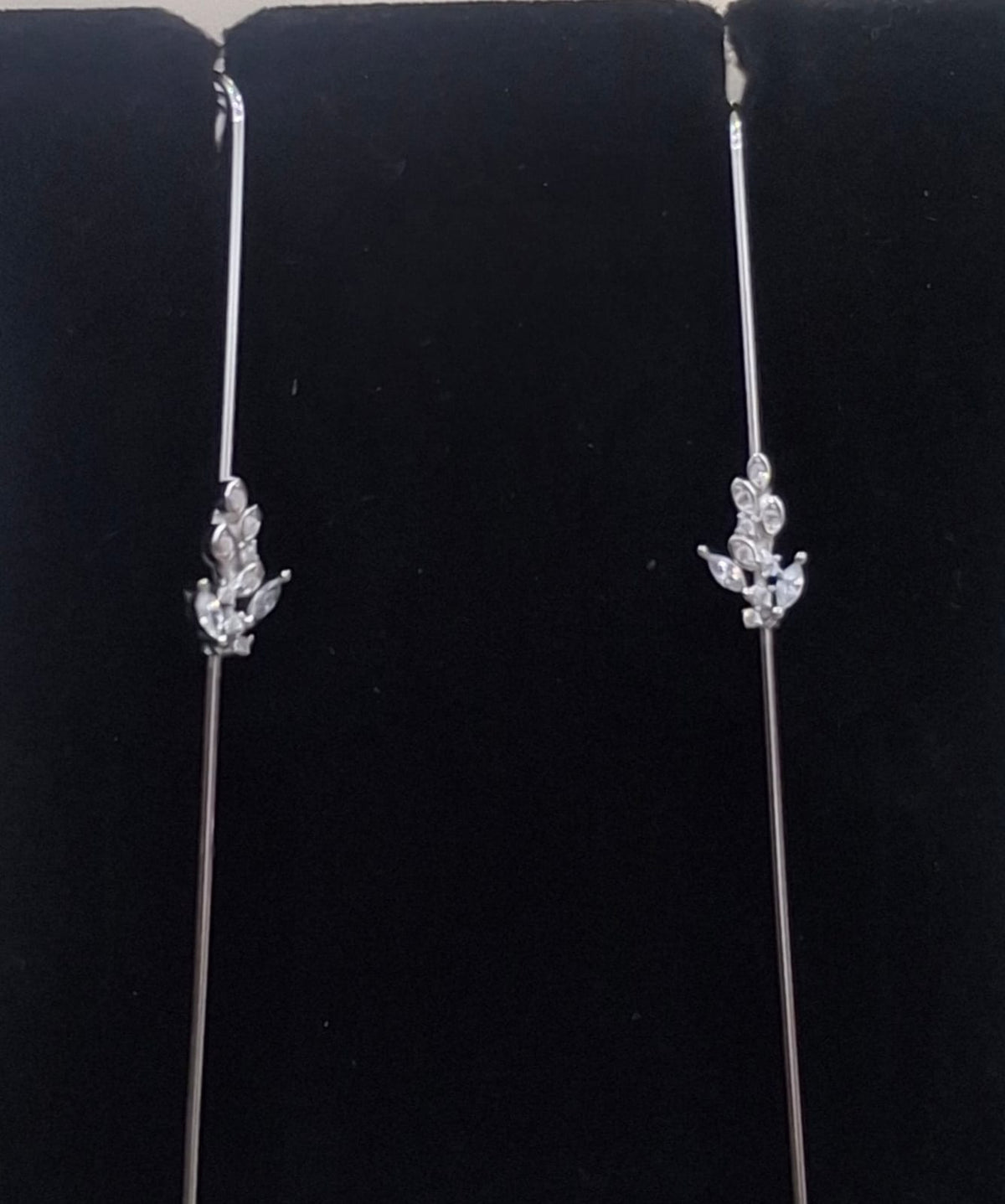 925 sterling silver ear needle pin with clear-stone leaf sprig, shown from front and side.
