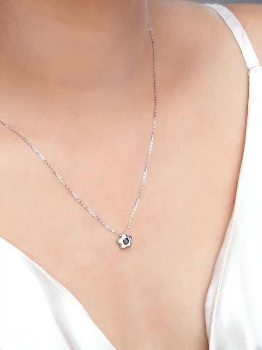 925 silver flower pendant necklace with black stone centerpiece on a fine chain