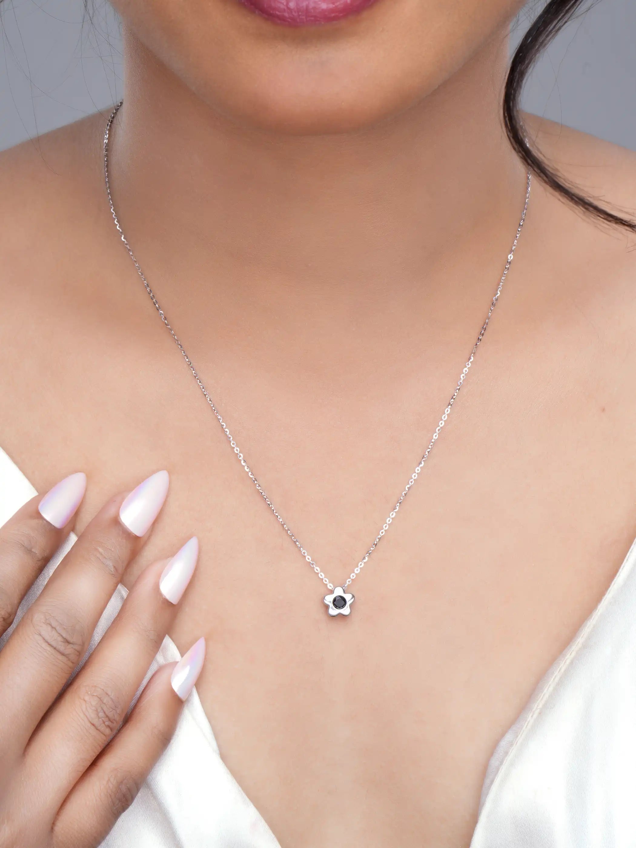 925 silver flower pendant necklace with black stone centerpiece on a fine chain