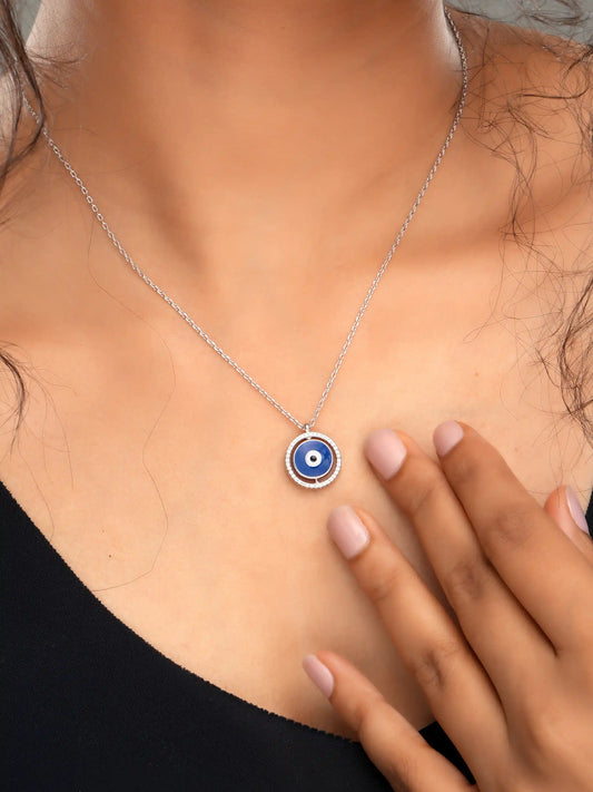 925 silver necklace with round blue evil eye pendant framed in silver detailing, symbolizing protection and modern elegance