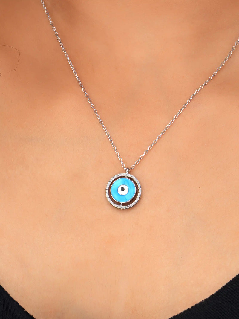 925 silver necklace with round blue evil eye pendant framed in silver detailing, symbolizing protection and modern elegance